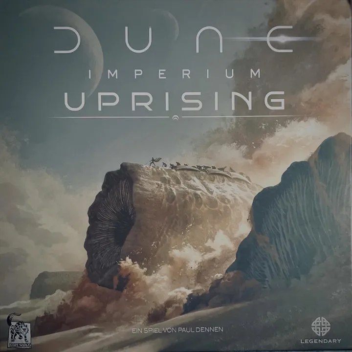 The German edition box of Dune: Imperium – Uprising, showing a giant sandworm rising from the desert