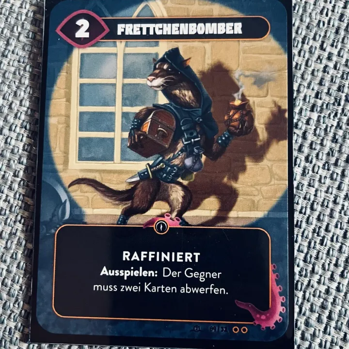 The Mindbug card Frettchenbomber (ferret bomber) on our sofa
