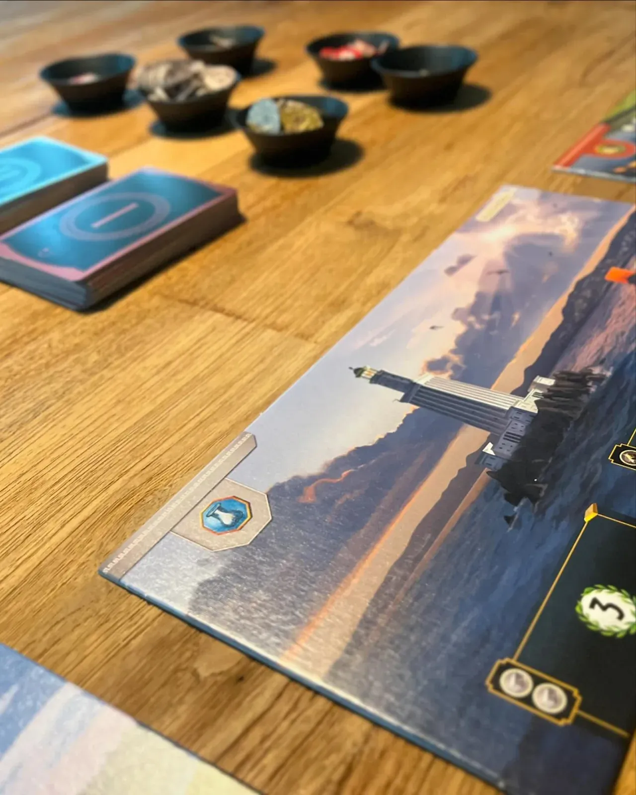 A 7 Wonders wonder board and cards on our table