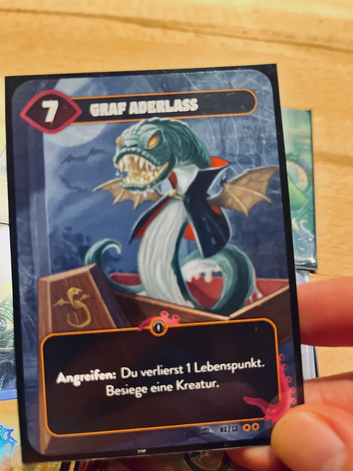 Die Karte Graf Aderlass (Stärke 7) aus Mindbug, in der Hand gehalten, aus der Erweiterung Neue Kreationen