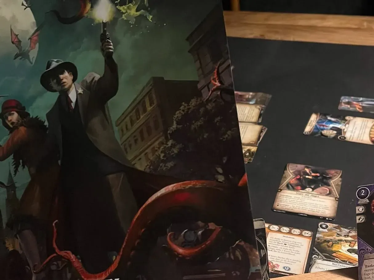 Arkham Horror cards with dark illustrations