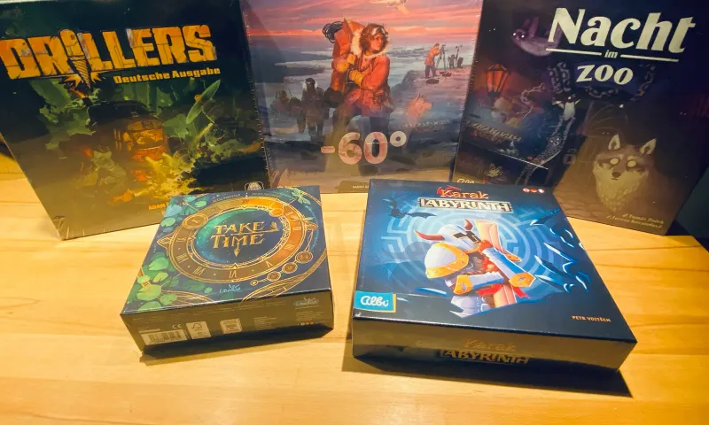 Unsere Ausbeute von der SPIEL Essen 2026 auf dem Tisch zu Hause: Drillers, -60°, Nacht im Zoo, Take Time und Karak: Labyrinth