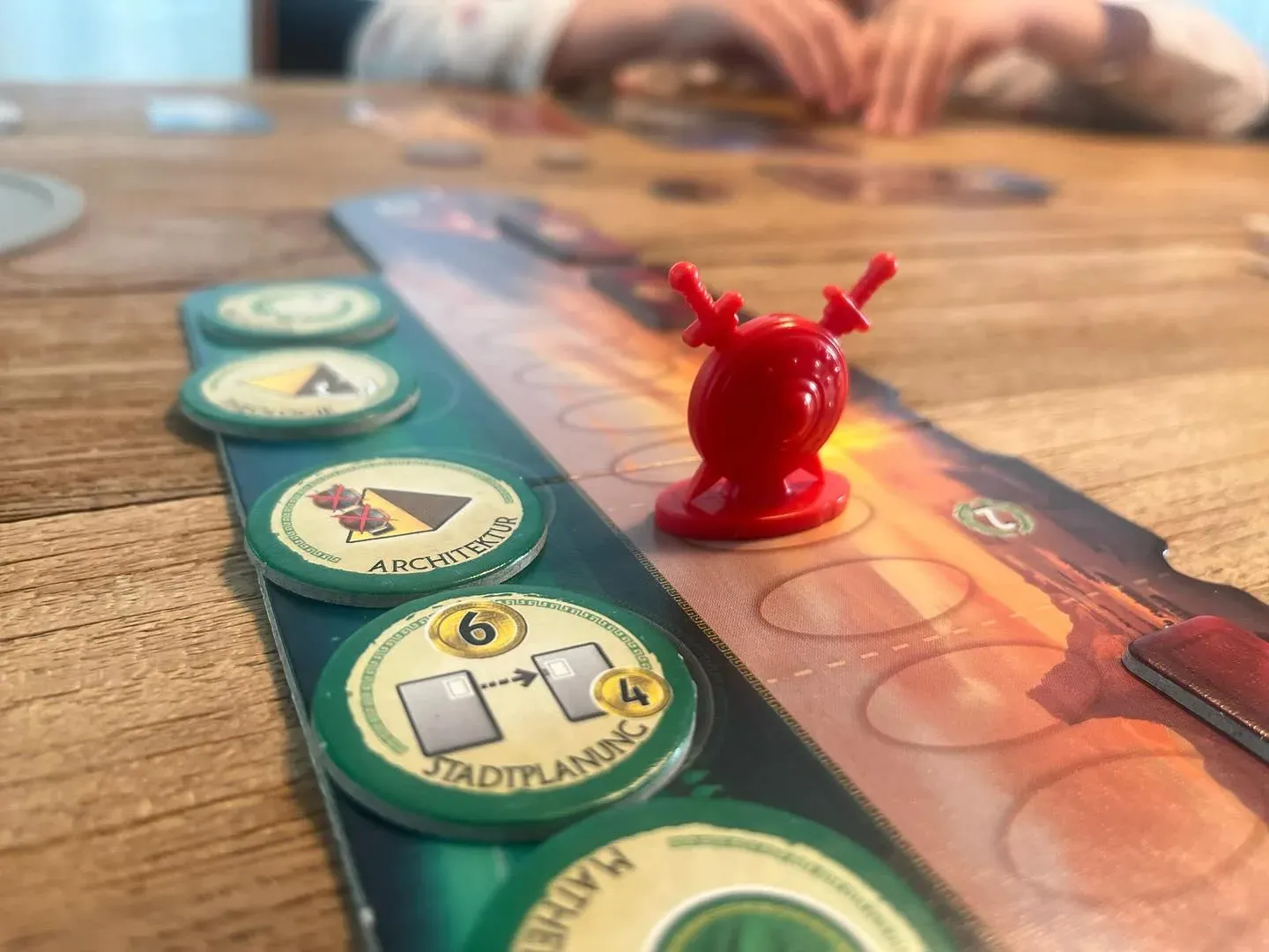 The 7 Wonders Duel military track with the red conflict pawn