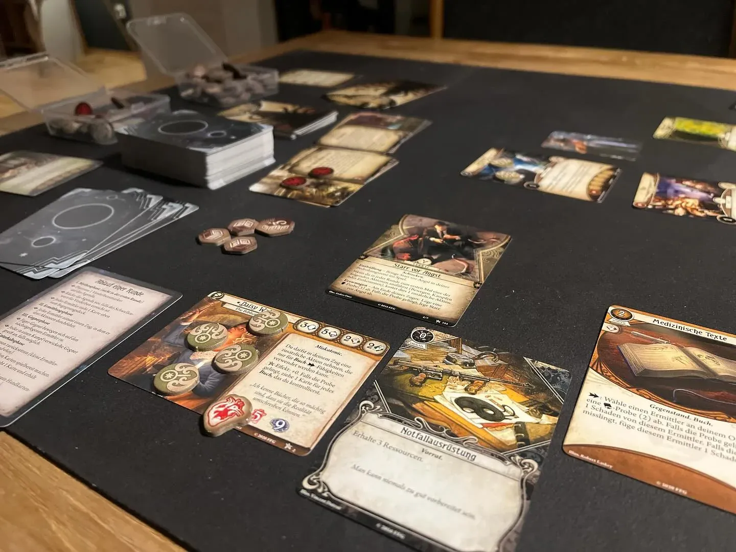 An Arkham Horror: The Card Game scenario laid out on a dark table