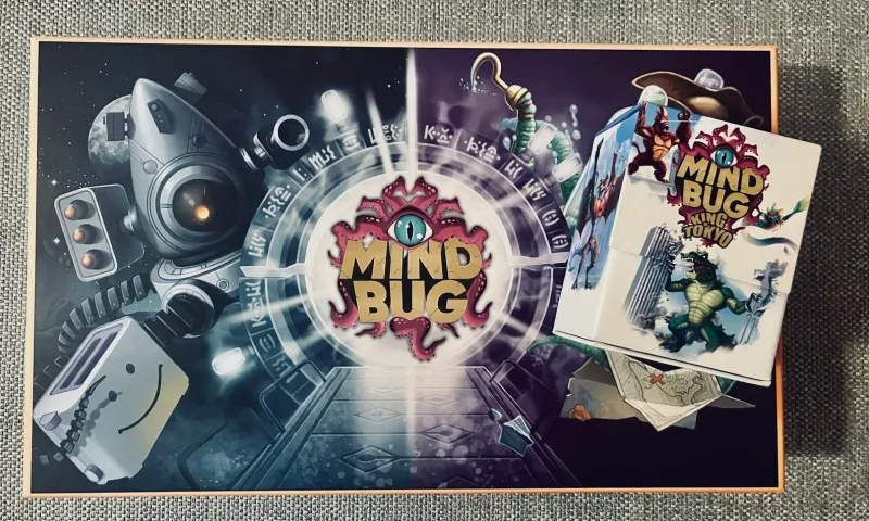 Der Deckel unserer Mindbug-Sammelbox, darauf die Box Mindbug x King of Tokyo